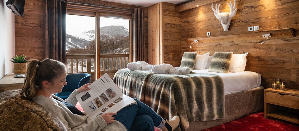 cozy room with mountain atmosphere and view of the resort with double bed